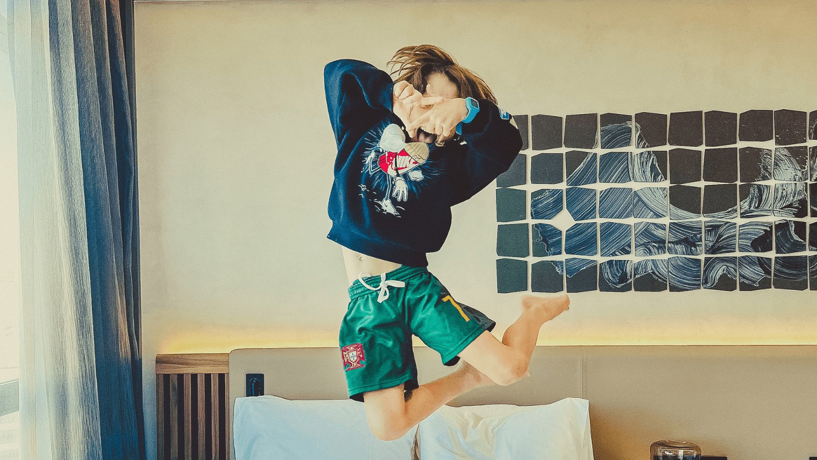 A young boy energetically jumps into the air