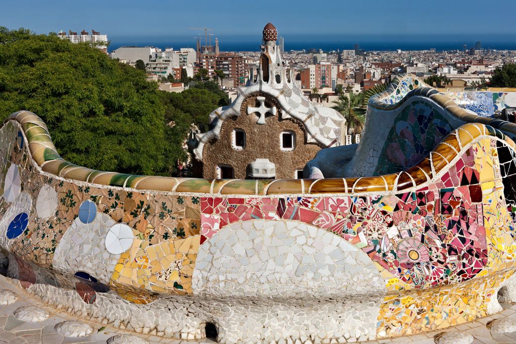 An artistic depiction of Park Güell in Barcelona, featuring its iconic designs and vibrant colors