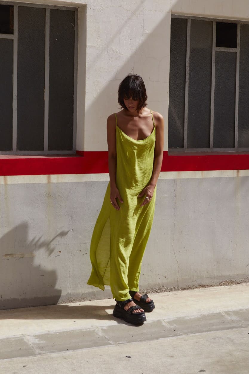 Woman standing on street in green dress
