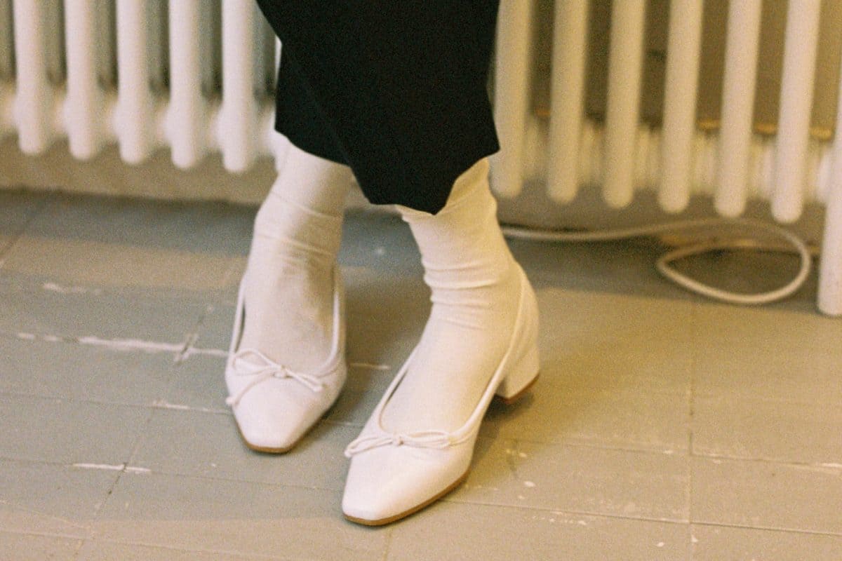 a pair of pointy white shoes