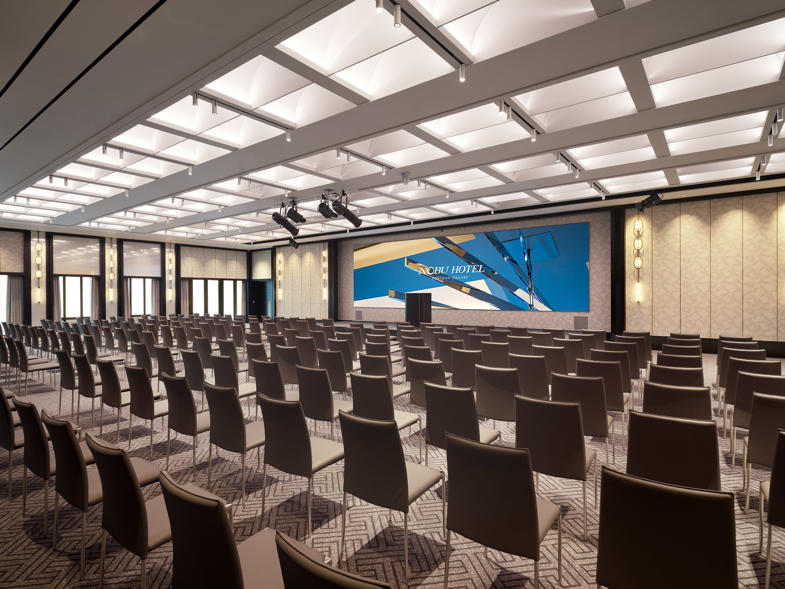 Many brown chairs for audience in a large meeting space