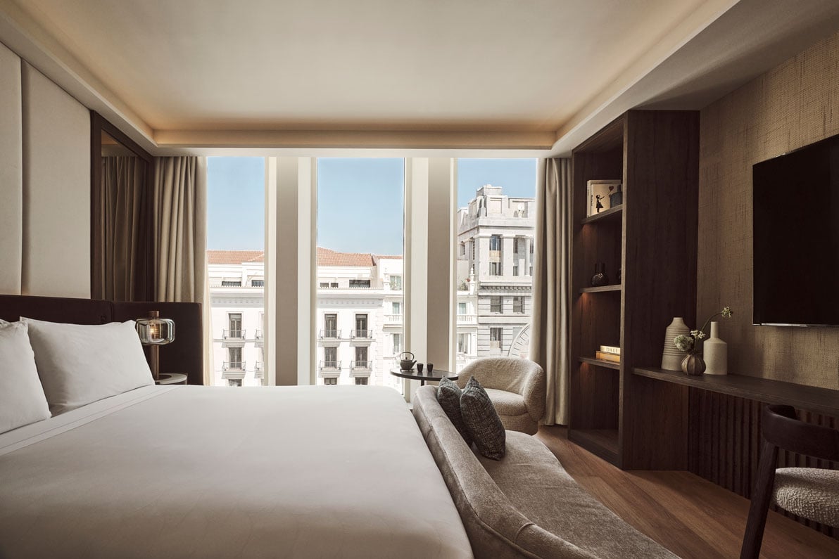 view of a bed and couch with a view of the city