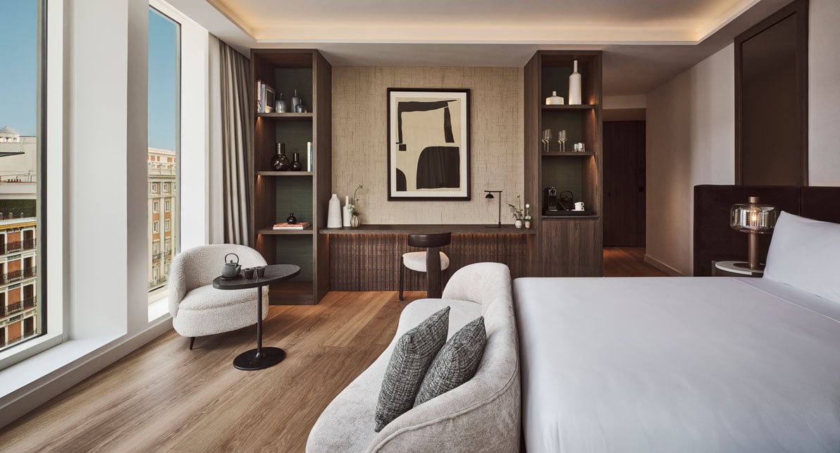 couch in front of a bed in a bedroom