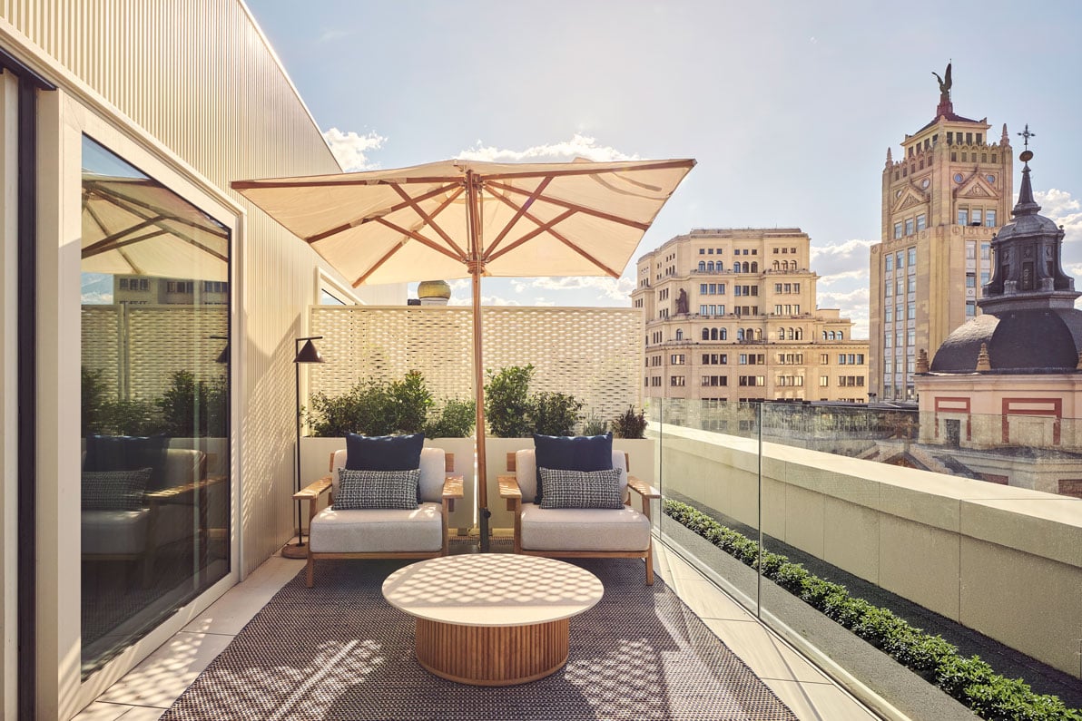 two chairs under an umbrella on the hikari suite balcony