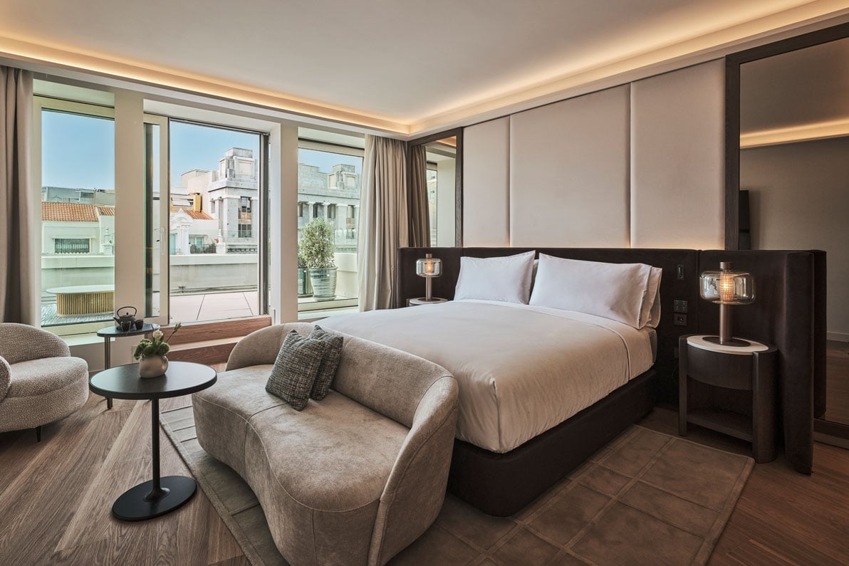 view of the bed and couch in the hikari suite bedroom