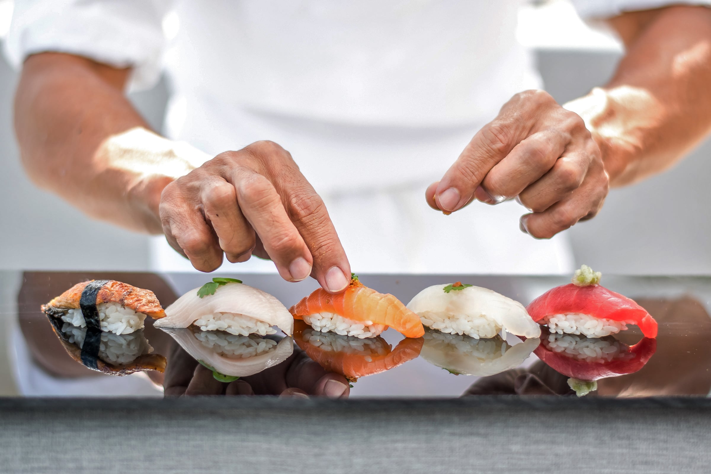a ched preparing sushi