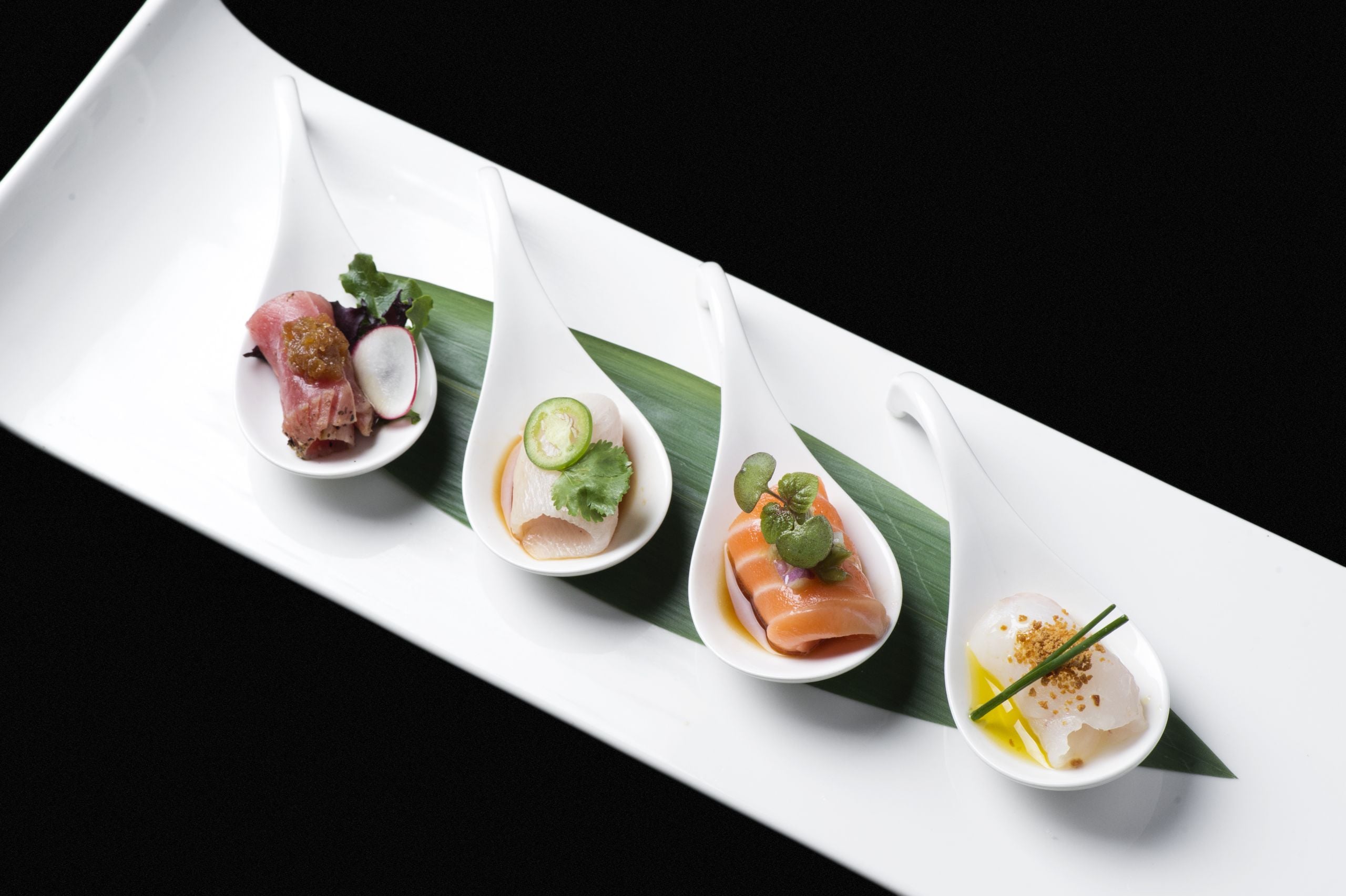 sashimi arranged on individual spoons