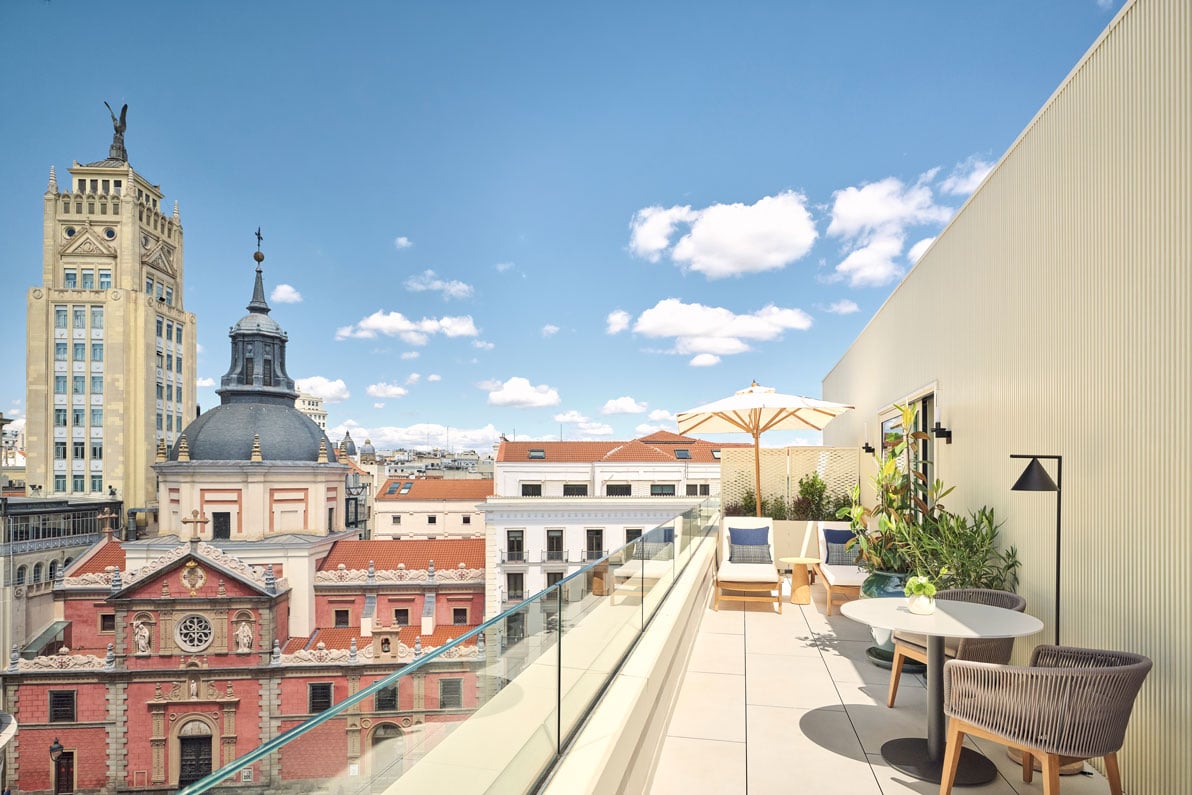 chairs on a balcony overlooking the city