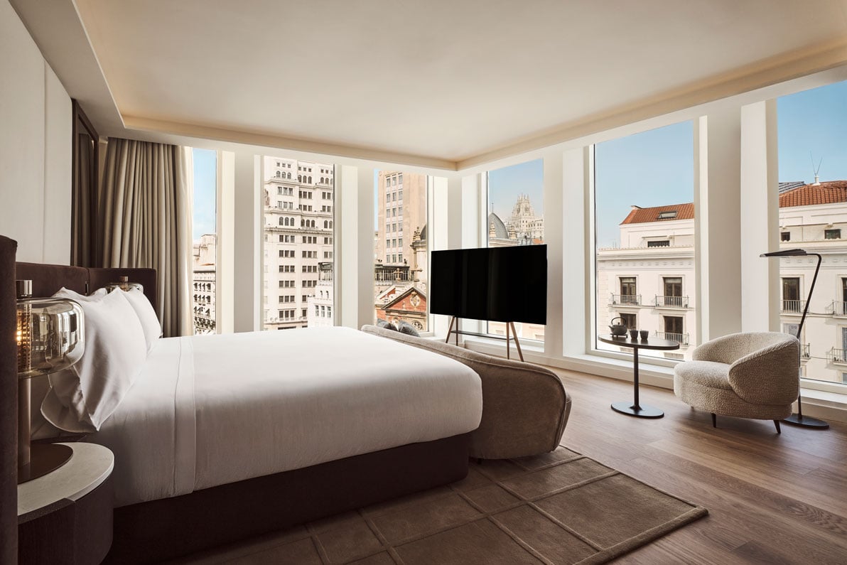view of the zen suite bedroom with view of the city