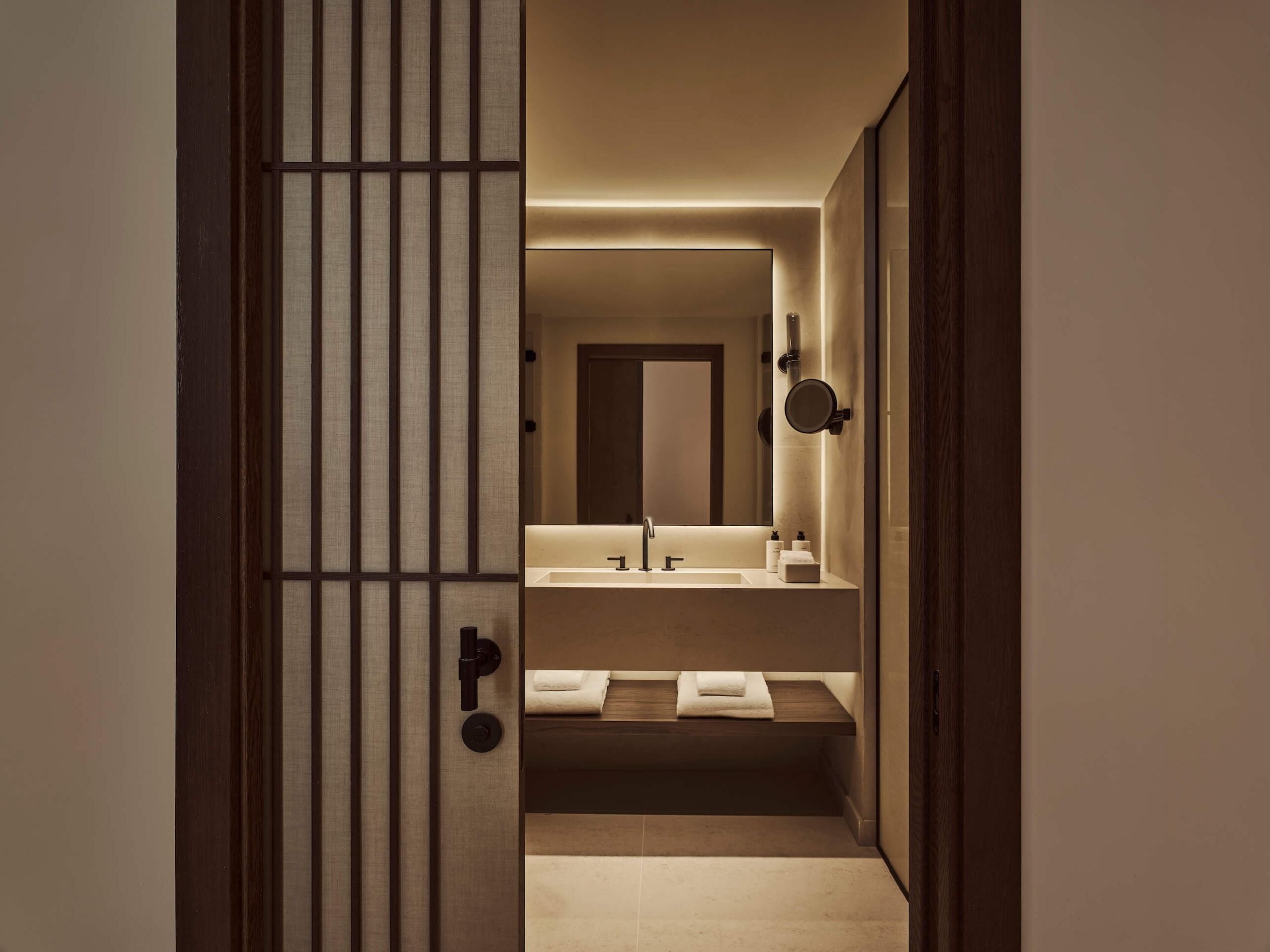 view of the bathroom past a door in the executive room
