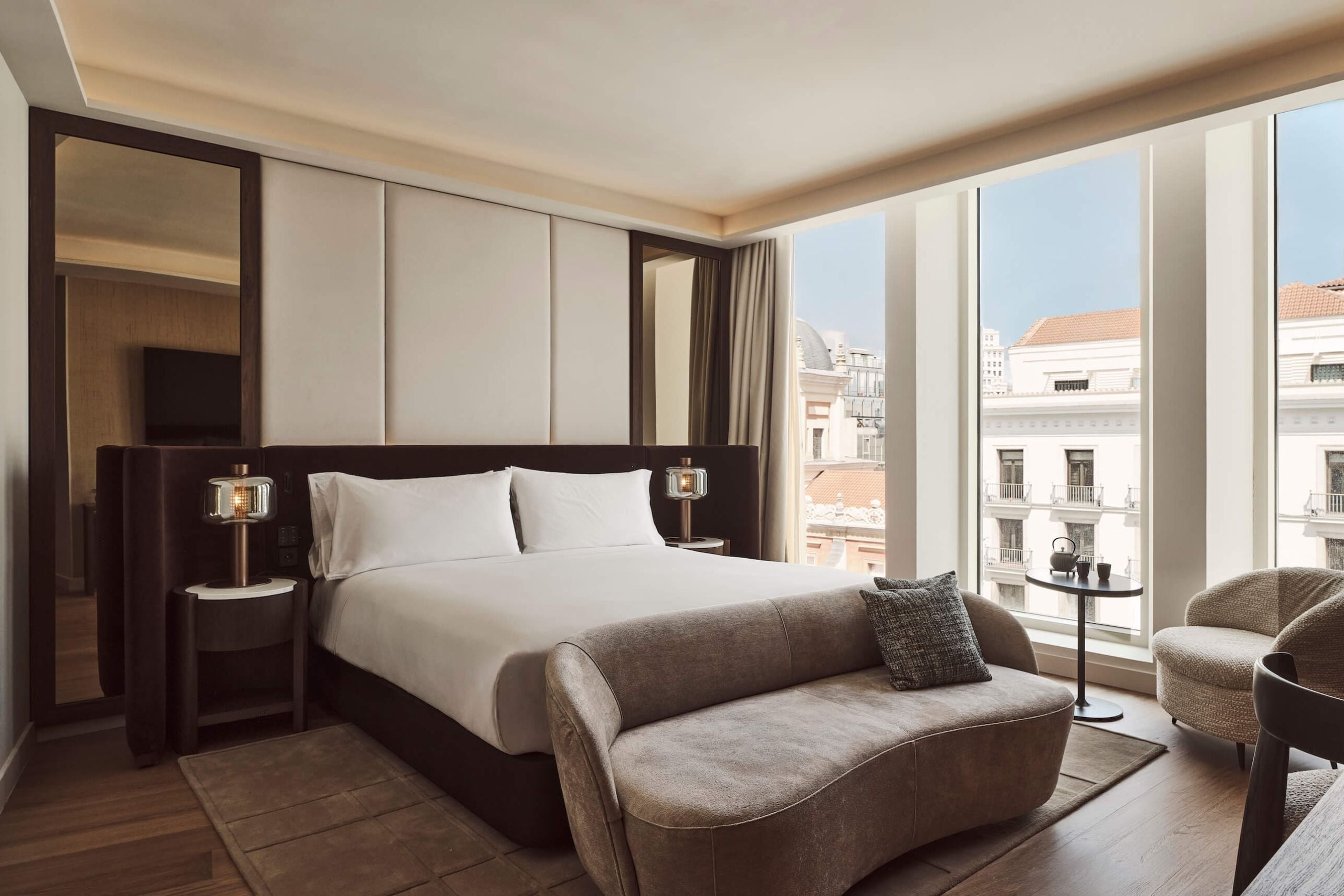 view of the bed and a view of the city from the executive room