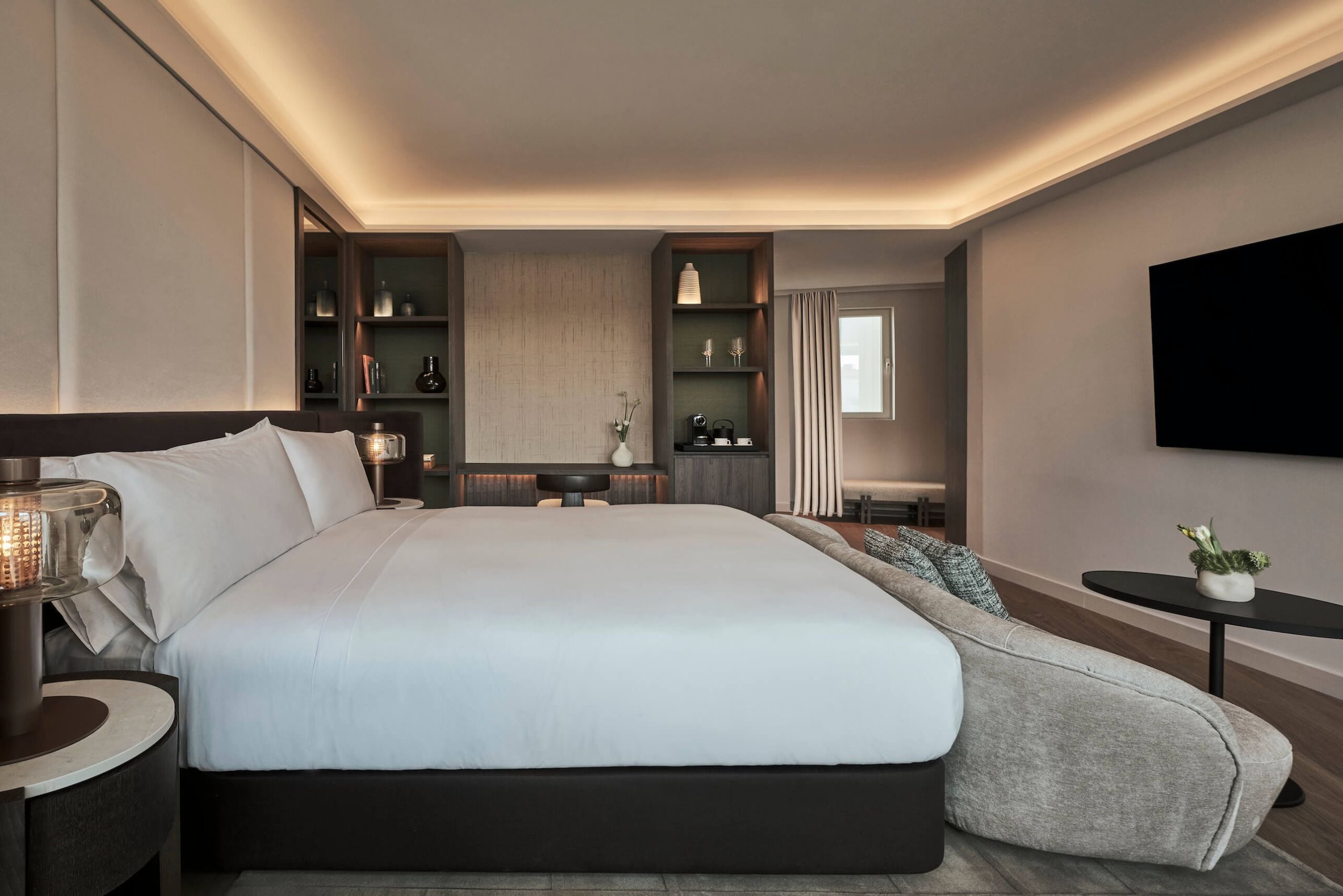 bed, couch and desk in the bedroom of hikari suite