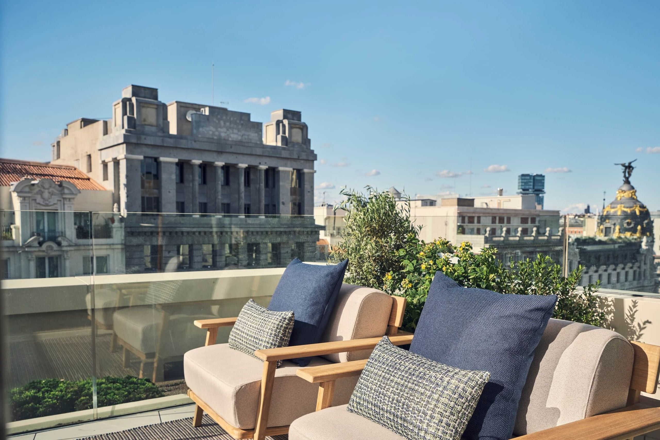 two chairs on the balcony of nobu suite overlooking the city