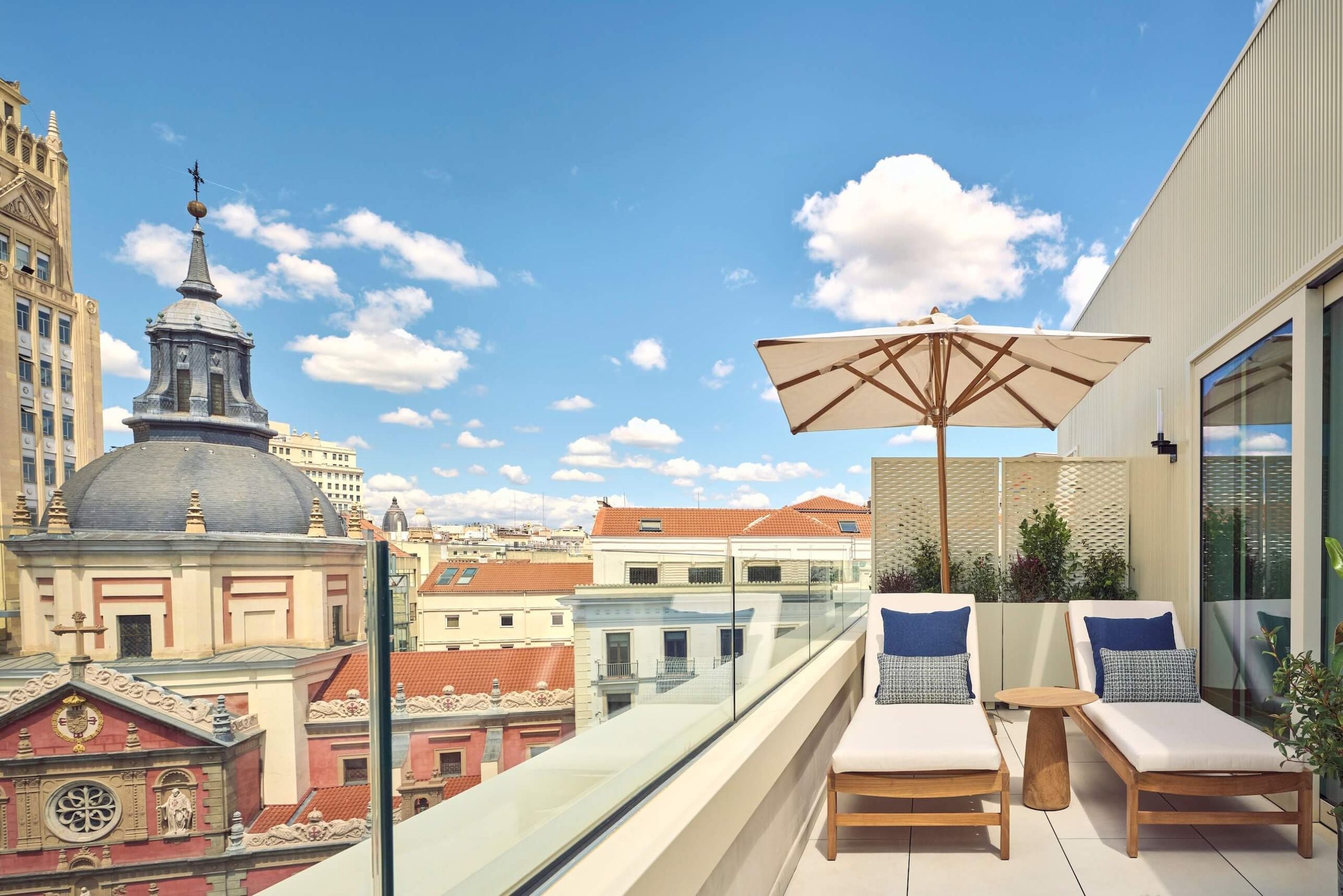 lounge chairs on the balcony of nobu suite overlooking the city