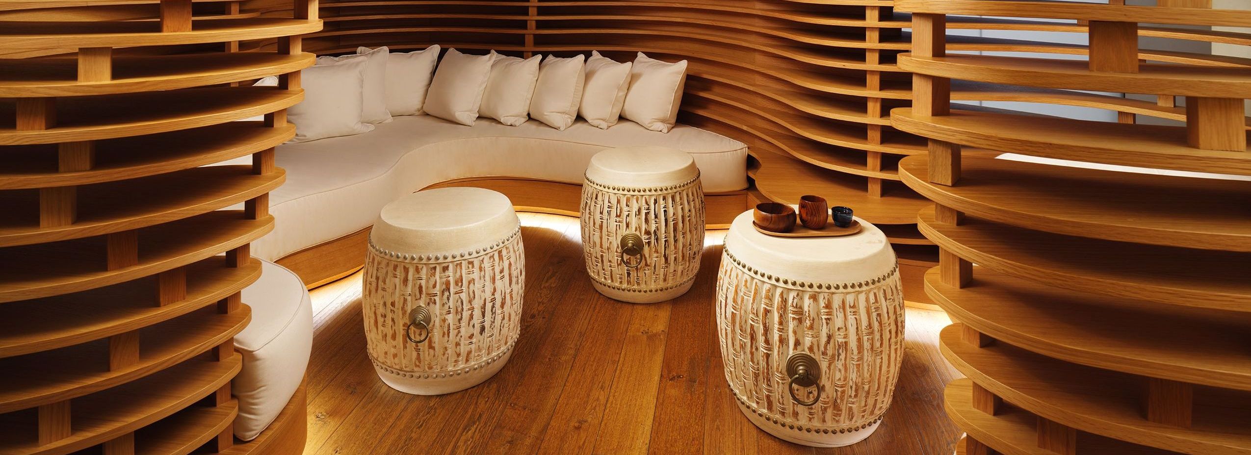 Cozy spa waiting area with natural wooden walls and floor, creating a calming atmosphere for guests to unwind