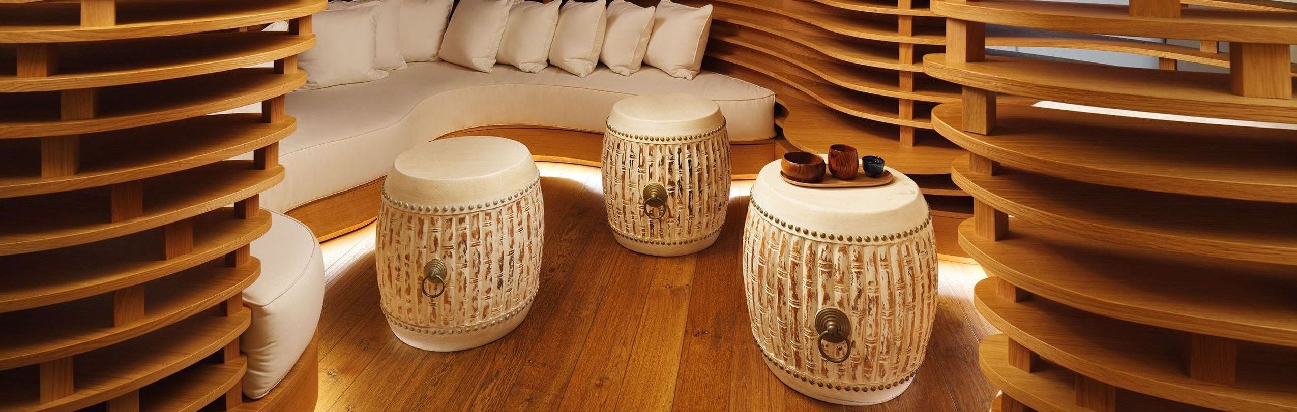 Cozy spa waiting area with natural wooden walls and floor, creating a calming atmosphere for guests to unwind