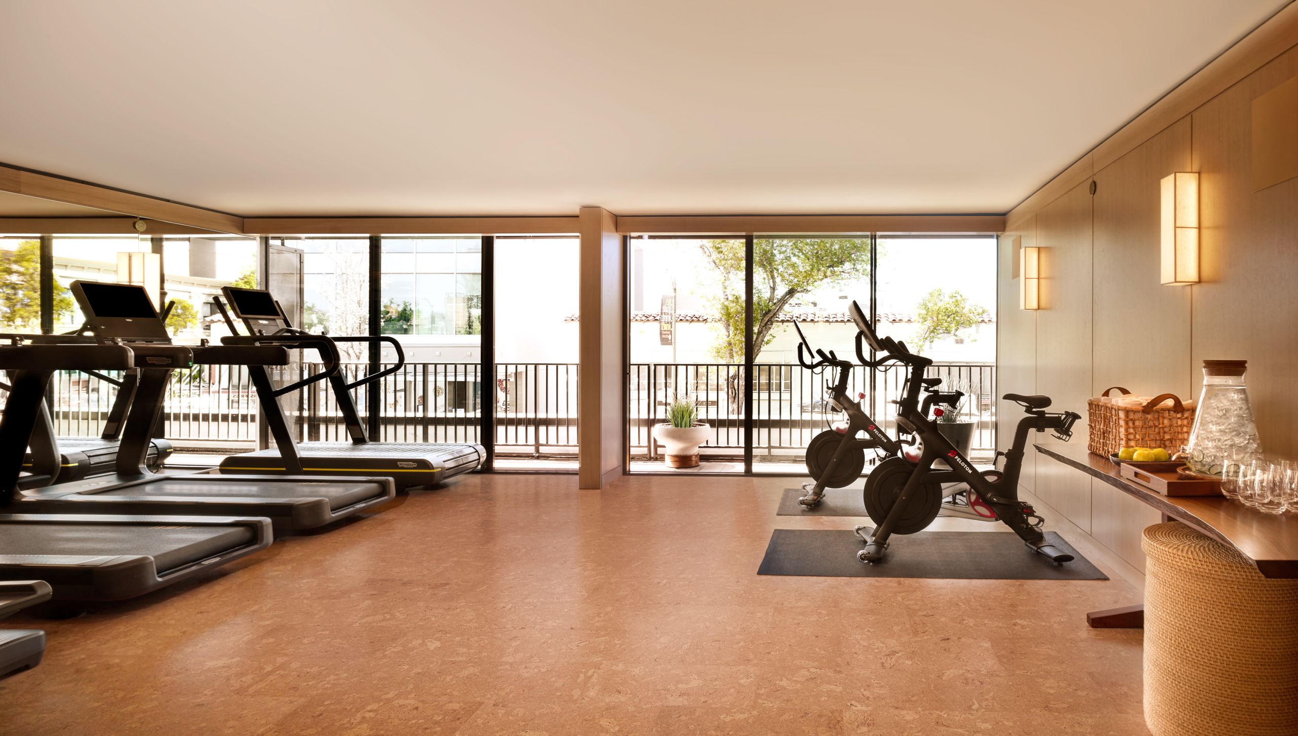 Nobu fitness room includes exercise bikes, treadmills. Off to the side is ice water and glasses for the guests.