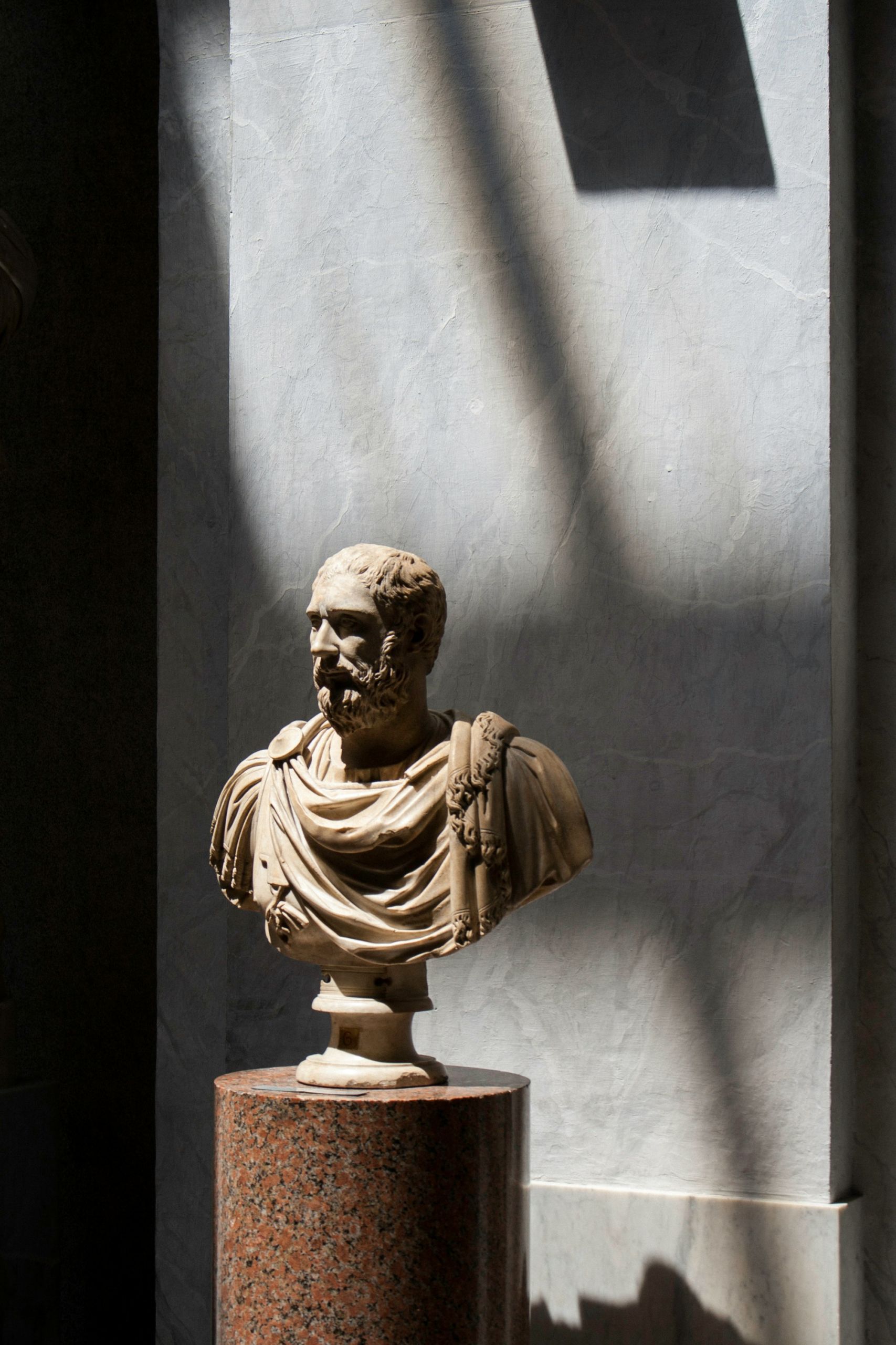 A bust of a roman man inside a building in Rome