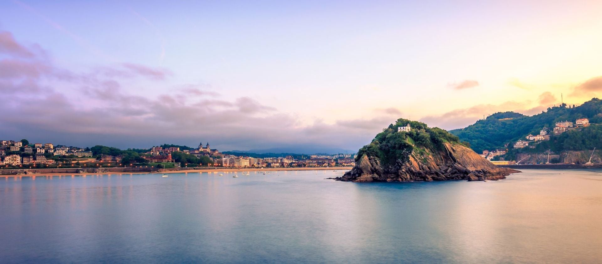 A tranquil small island in the ocean under beautiful sky, highlighting the coastal charm of San Sebastian
