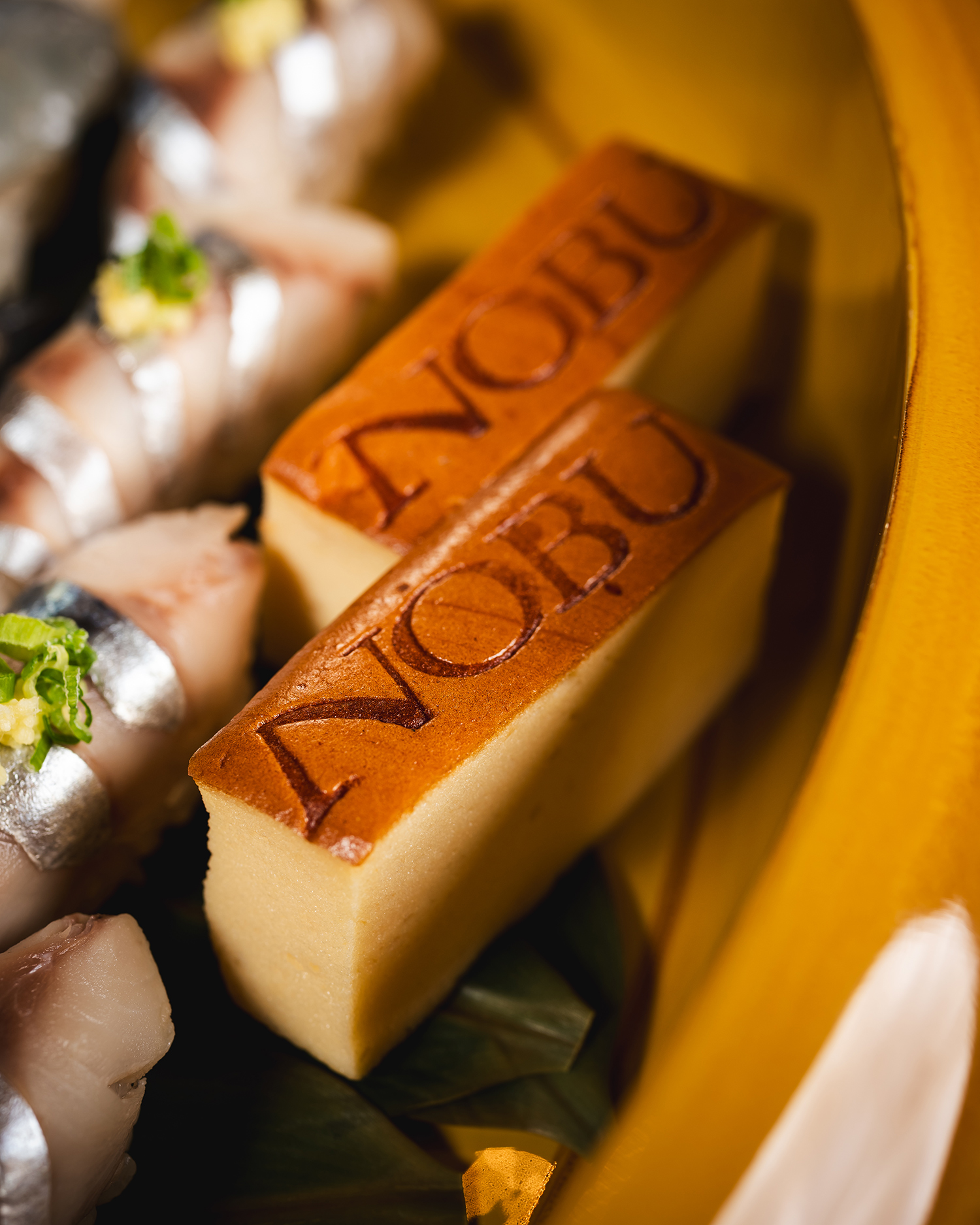 A beautifully arranged plate showcasing Nobu's signature dishes.